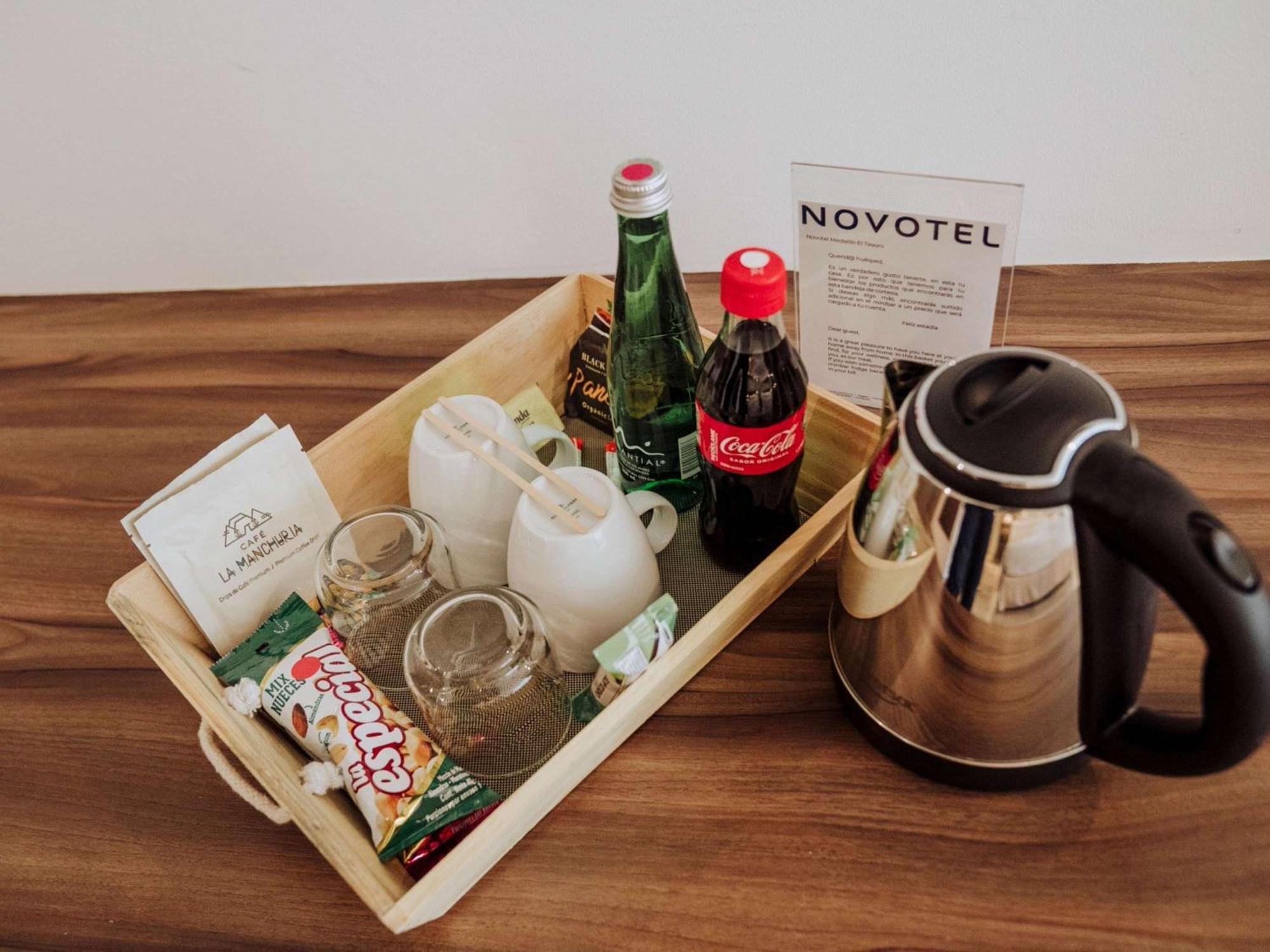 Novotel Medellin El Tesoro Экстерьер фото A kettle and a tray of snacks and drinks in a hotel room